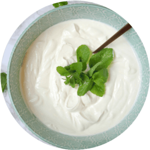 yogurt in a bowl with mint leaves on top